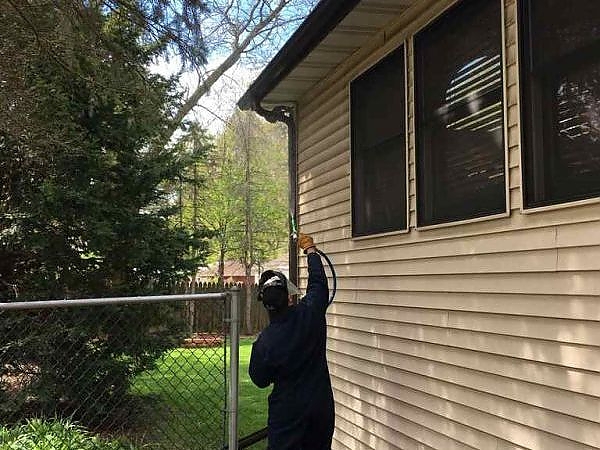 A person cleaning a house in Oswego, pest-free